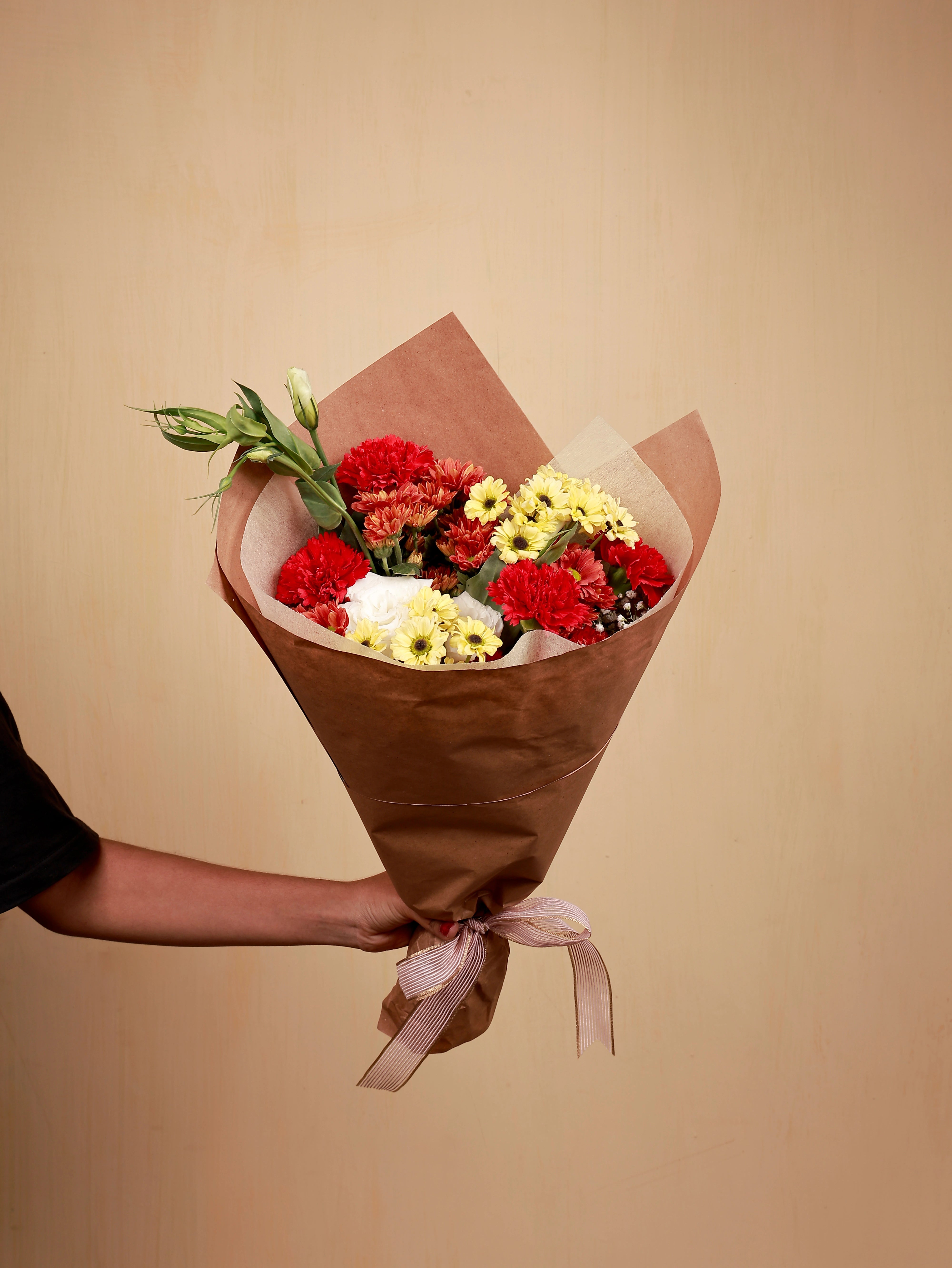 A bouquet of Eustma and carnation with yellow santinis